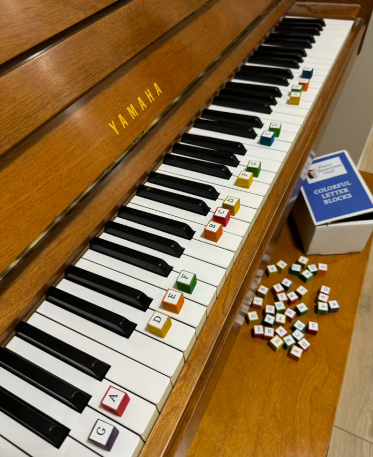 Colorful Letter Blocks placed on their corresponding piano keys